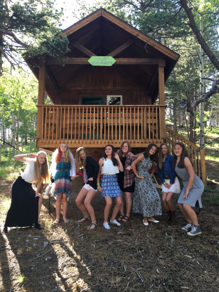 Camp Counselor and Campers pose outside cabin dressed up for banquet! 